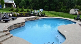 Free form pool with rock with raised stone wall
