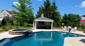 Freeform pool with raised spa and patio cover