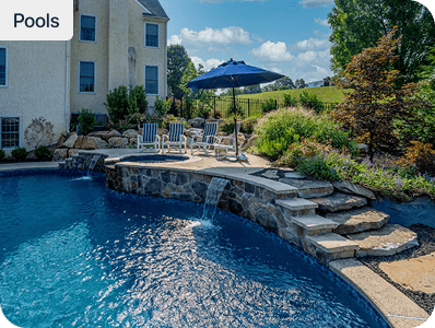 Concrete inground pool installation by Blue Tree Outdoor Living