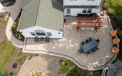 Aerial view of a curved paver patio by Blue Tree Outdoor Living