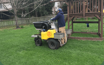Blue Tree technician treating a healthy green lawn in Southeastern PA