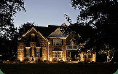Landscape lighting illuminating a home and yard by Blue Tree Outdoor Living