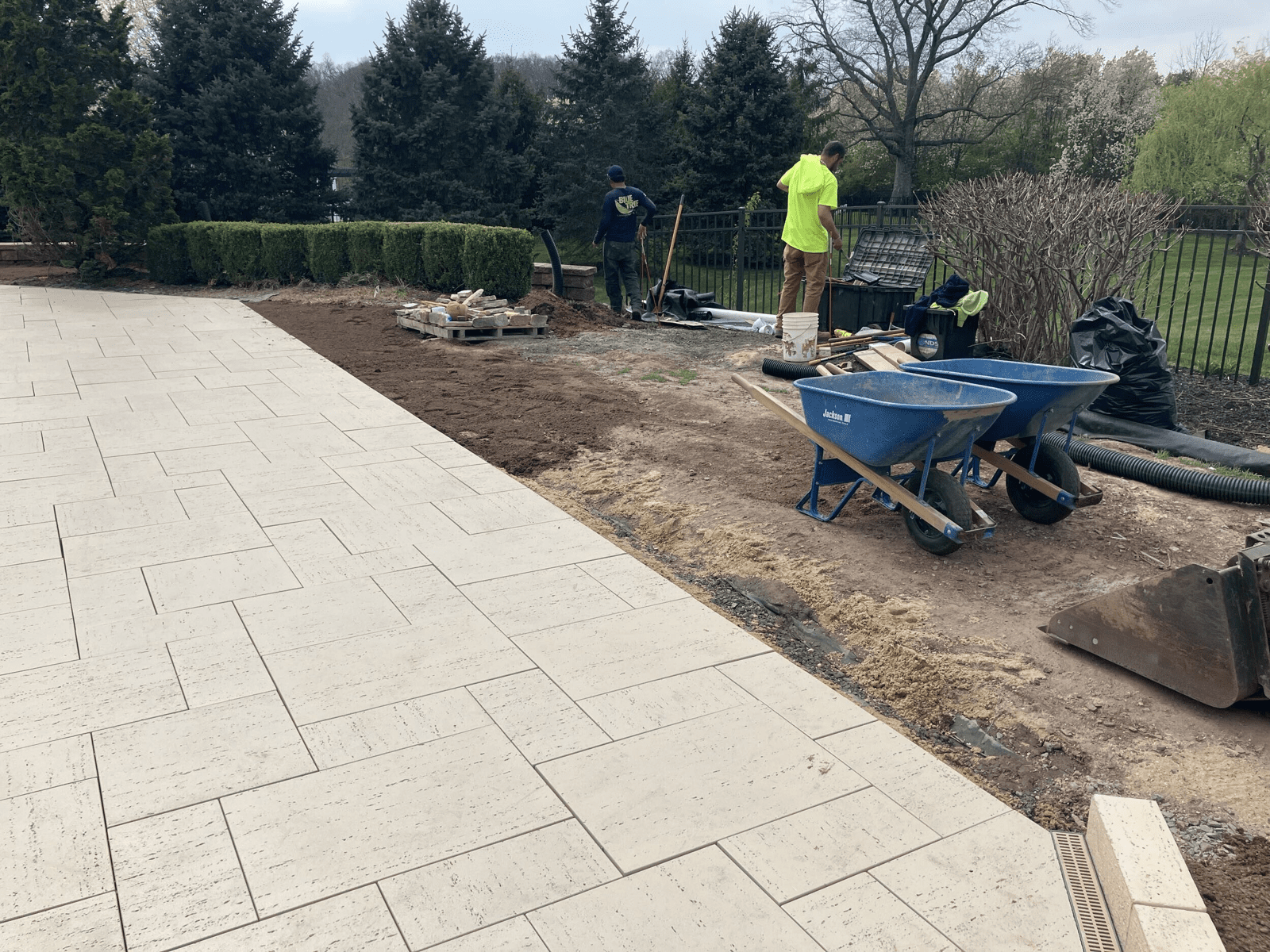 New travertine patio being installed during the Collegeville renovation by Blue Tree Outdoor Living