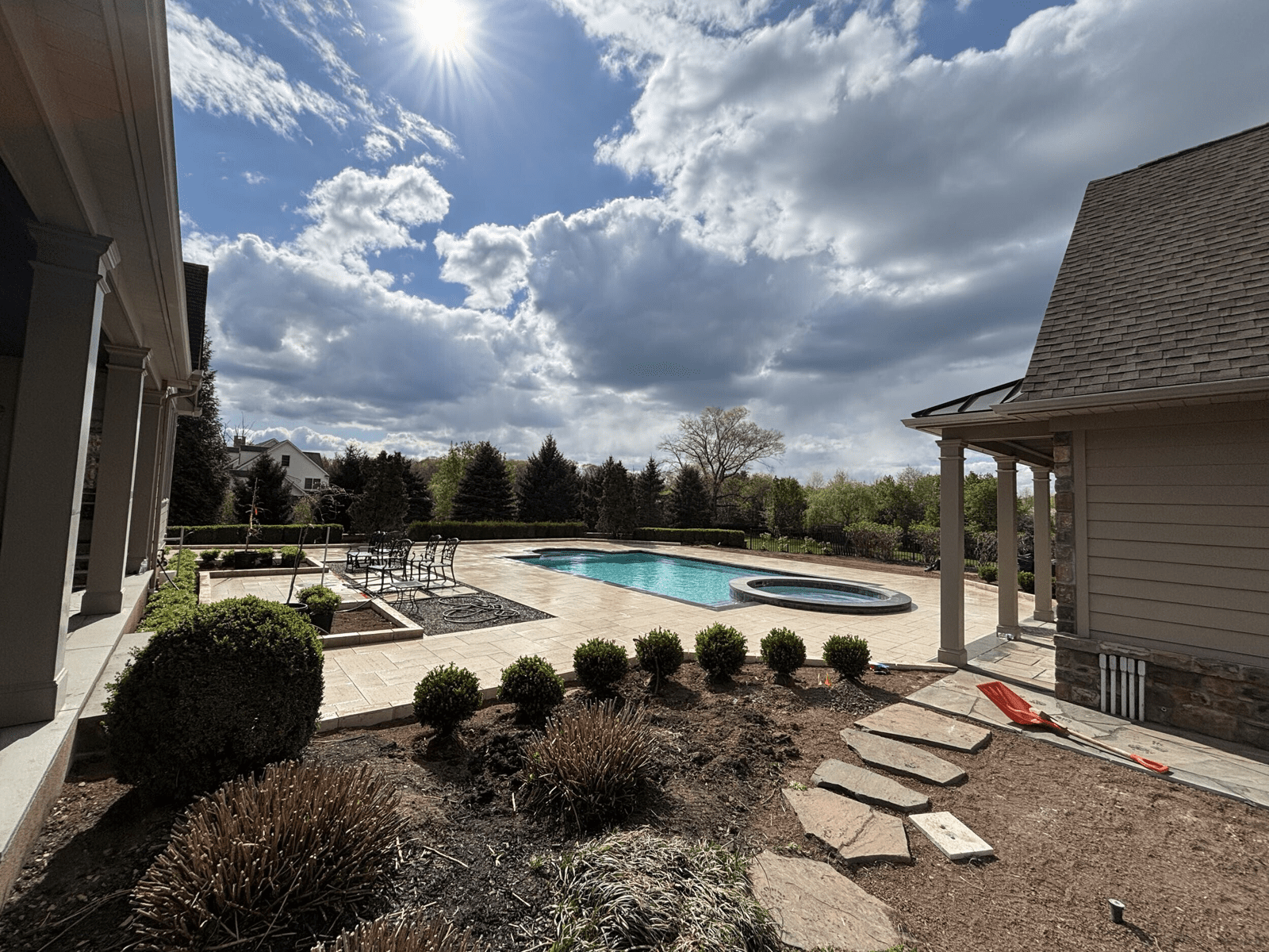 Completed pool and patio with new plantings in Collegeville, Pennsylvania by Blue Tree Outdoor Living