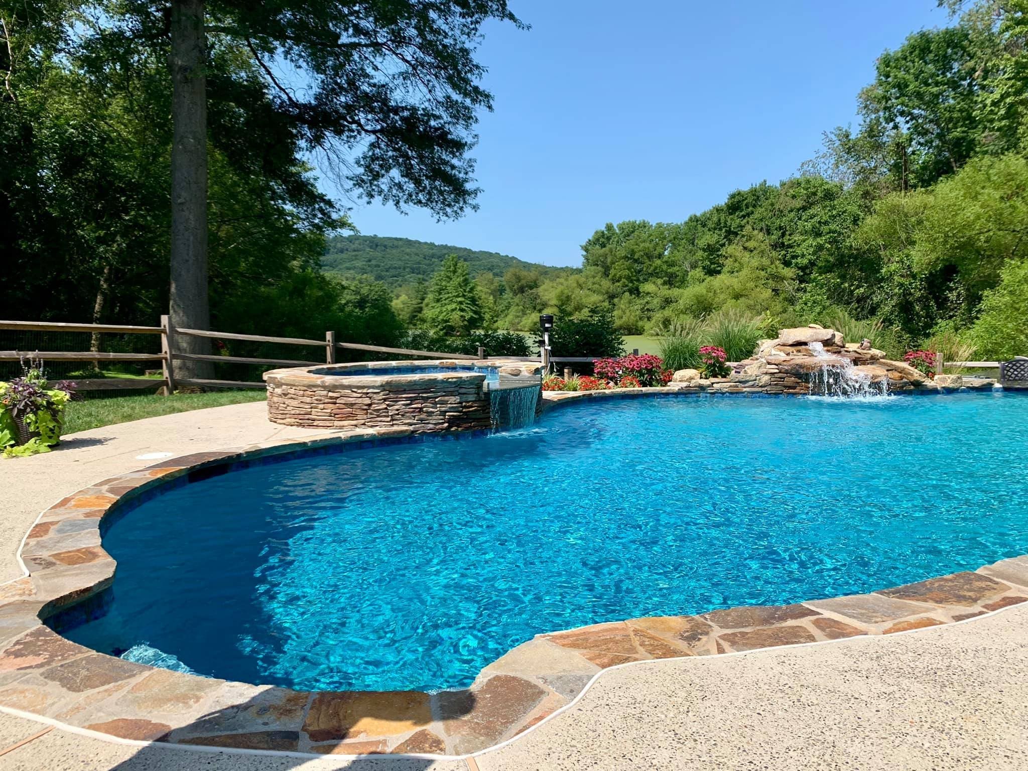Phoenixville Resort-Style Backyard, finished custom pool, boulder waterfall, and landscaping
