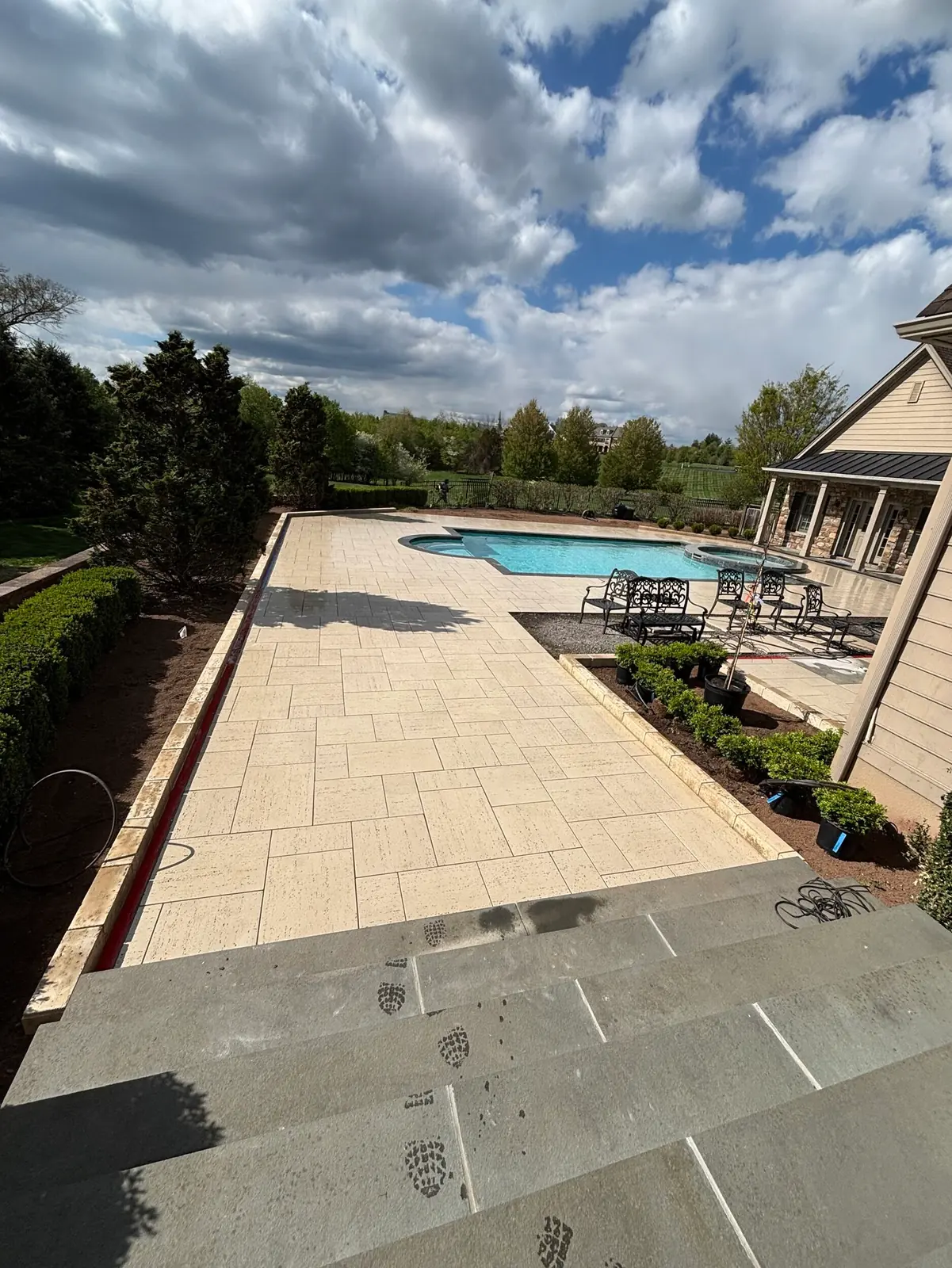 Wide view of a renovated pool and patio in Collegeville, PA