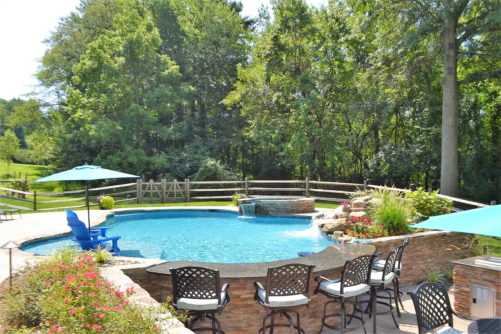 Finished pool, raised spa, and outdoor kitchen seating in Phoenixville, PA