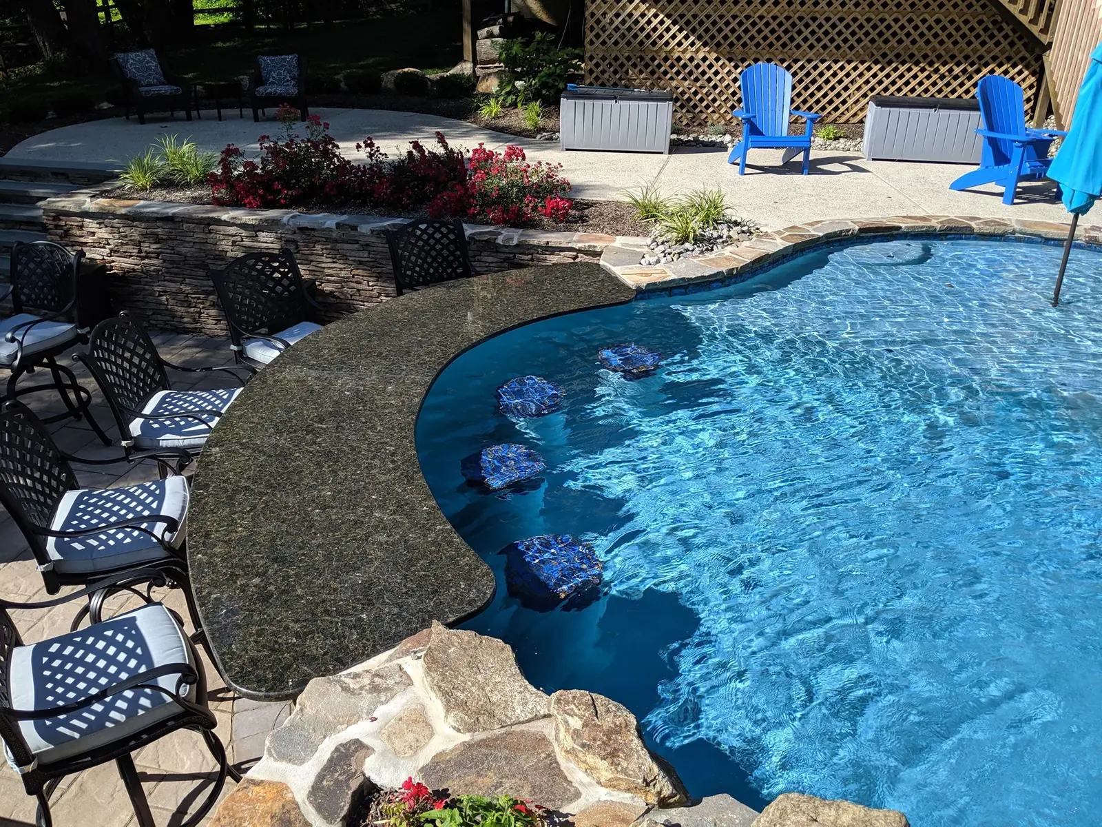 Swim-up bar stools and stone counter at a Phoenixville pool
