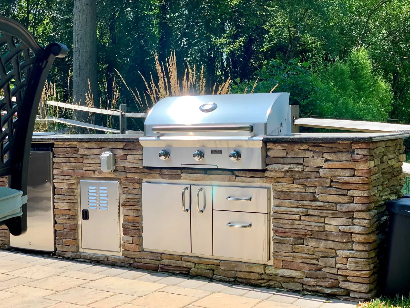 Stone outdoor kitchen with grill and storage in Phoenixville, PA