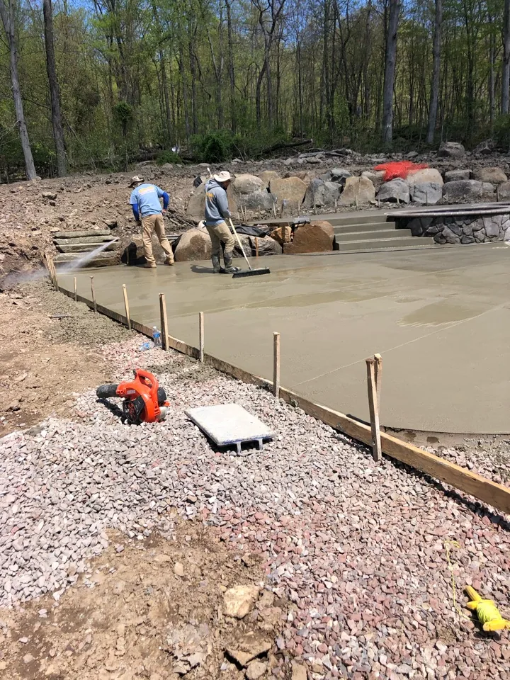 Crew placing a concrete pool deck during construction in Pottstown, PA
