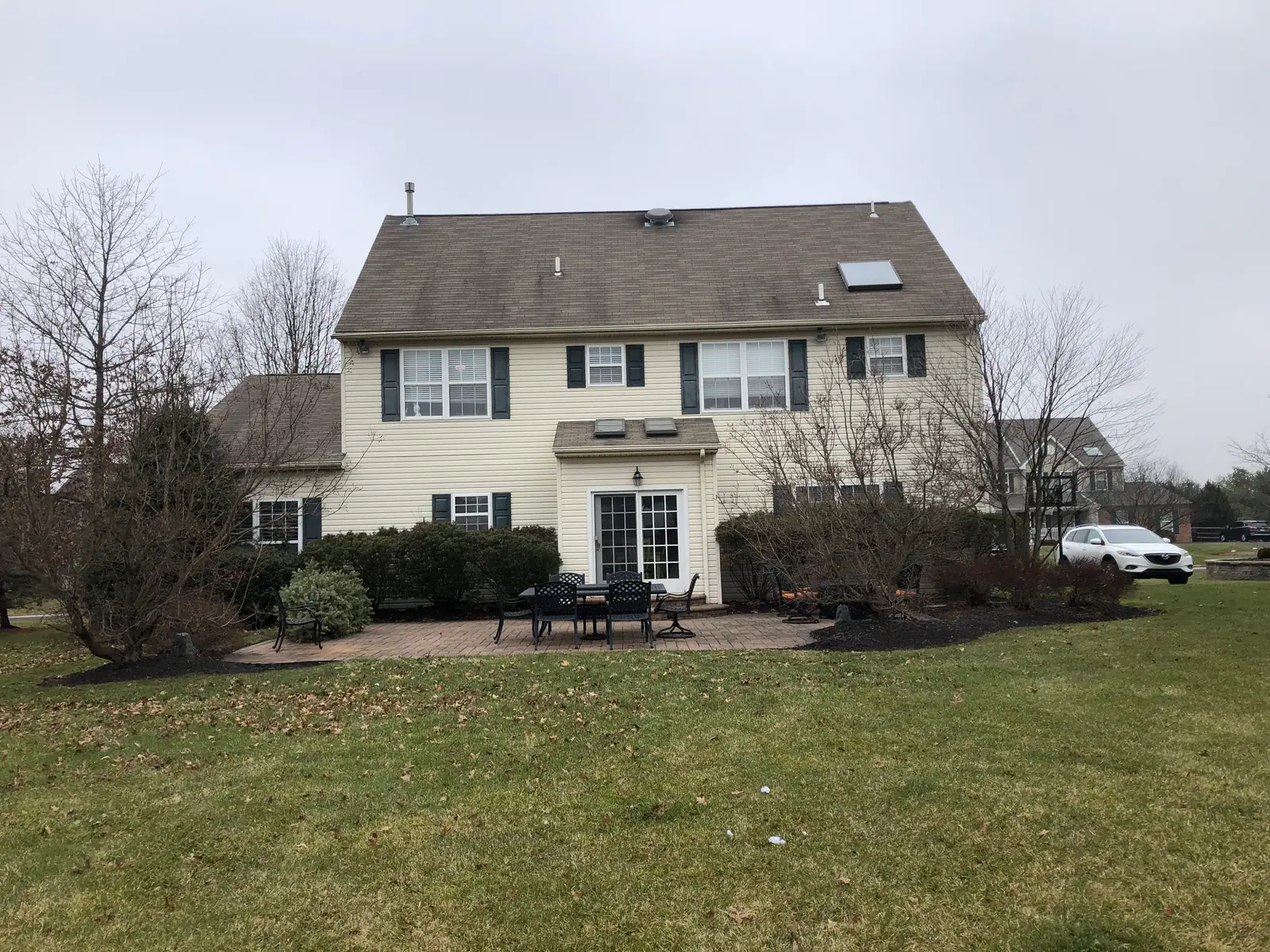 Backyard patio and lawn before an outdoor living renovation in Skippack, PA