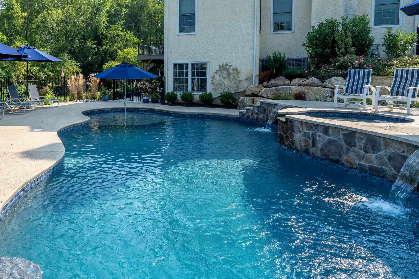 Pool, raised spa, stone wall, and spillways in West Chester, PA